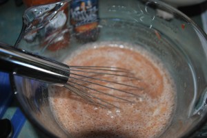 The cooking liquid composed of beer, brown sugar and chilli sauce